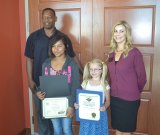 Lemoore students Grace  Berkenkamp, Akers School, and Mializeth Inocencio, from Central Union, were honored by FAST Credit Union and Assemblyman Rudy Salas' representative Damian Douglas.